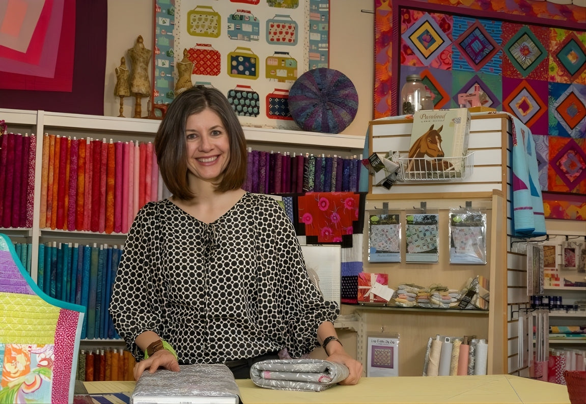 stitch-durango-colorado-LeeAnn_at_Stitch_Counter_with_Fabrics-Stitch Durango Stitch Durango Colorado Quilt & Sewing Shop